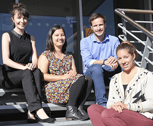 Dr Annie McDougall, Melinda Dolan-Curosurf, James Aridas and Courtney McDonald sitting on the steps at Hudson Institute