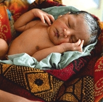 Baby from Lucknow, India sleep peacefully in the comfort of colourful blanket.