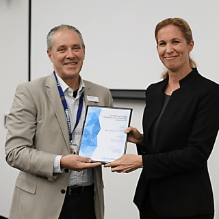 Dr Frances Milat receiving her award from Monash Health CEO, Mr Andrew Stripp.