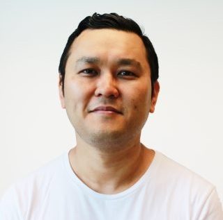 Dr Joohyung Lee, Honorary Research Associate, working at the lab bench and using a microscope to assist with his medical research