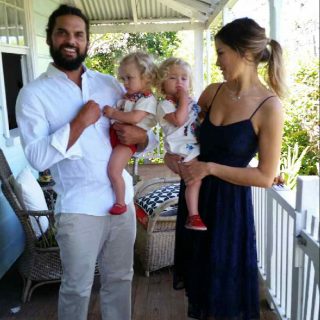Endometriosis case study, Kat, pictured on the balcony with her husband and children.