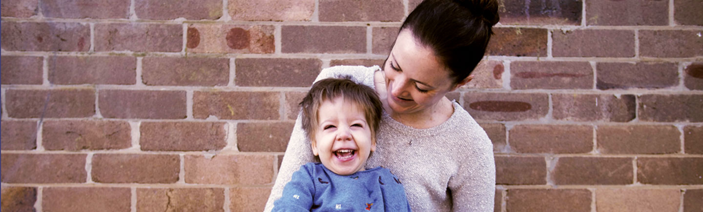 Arlo laughing with his mother Melanie