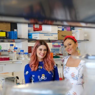 Scientists, Dr Amy Wilson and Dr Maree Bilandzic all dressed up in the lab in stunning dresses, supporting OCRF Frocktober