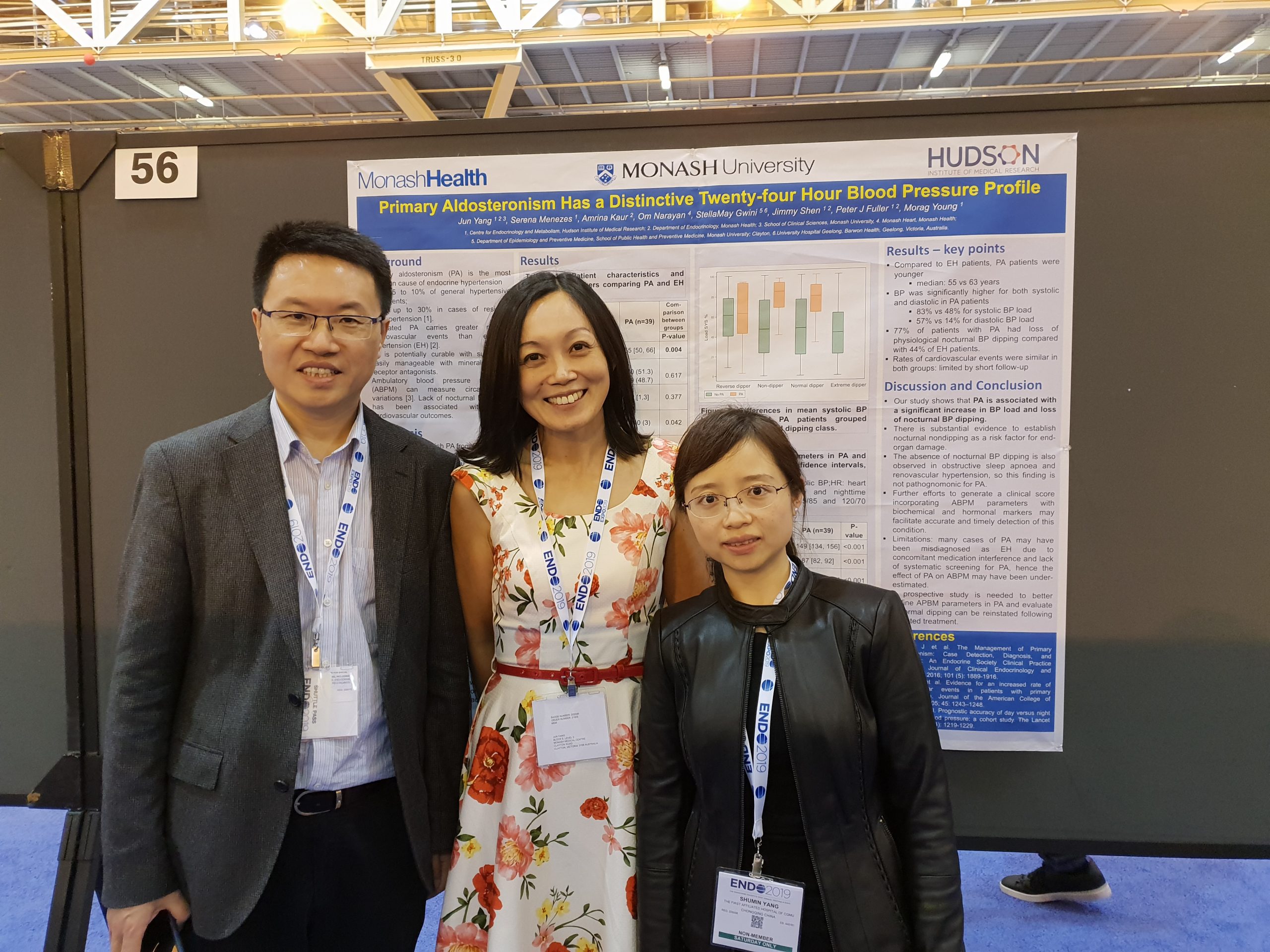 Professor Qifu Li, Dr Jun Yang, Dr Shuming Yang standing together in front of Jun's scientific poster at the 2019 US Endo Society conference in New Orleans