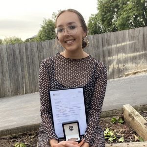 PhD Student, Sharmony Kelly proudly shows off her Sir John Monash medal for prevention research in newborn brain injury.