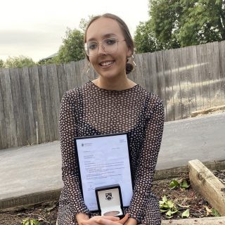 PhD Student, Sharmony Kelly proudly shows off her Sir John Monash medal for outstanding academic achievement in biomedical science