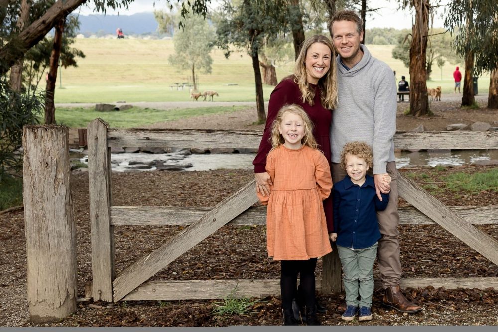 Carly and Ryan with their children, Isabelle and Lachy pictured outside in a scenic park