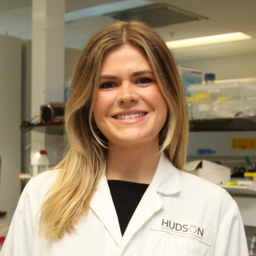 Madeleine Smith in her lab coat conducting cerebral palsy research.