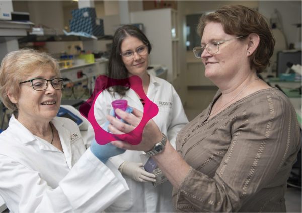 Professor Caroline Gargett and Dr Caitlin Filby showing patient Nicole Fernley a donation menstrual fluid cup which may help towards ending endometriosis.