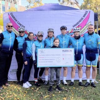 Eight-year-old Neve presents fundraising cheque to riders finishing Ride4Research.