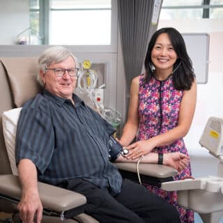 Associate Professor Jun Yang and clinical trial patient David