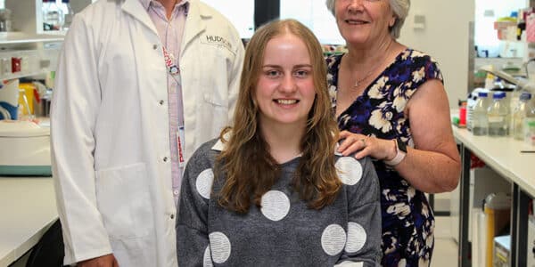 Dr Jason Cain in his lab with supporter Mrs Ann Lorden and her granddaughter, Ella, an osteosarcoma survivor
