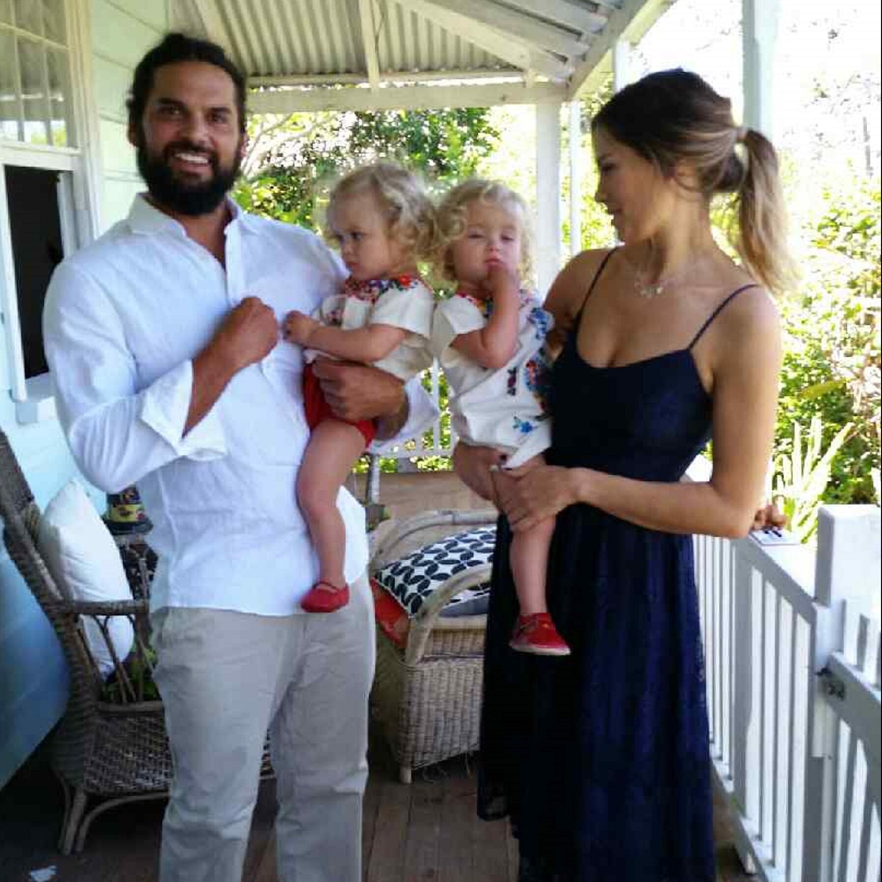 Endometriosis case study, Kat, pictured on the balcony with her husband and children.